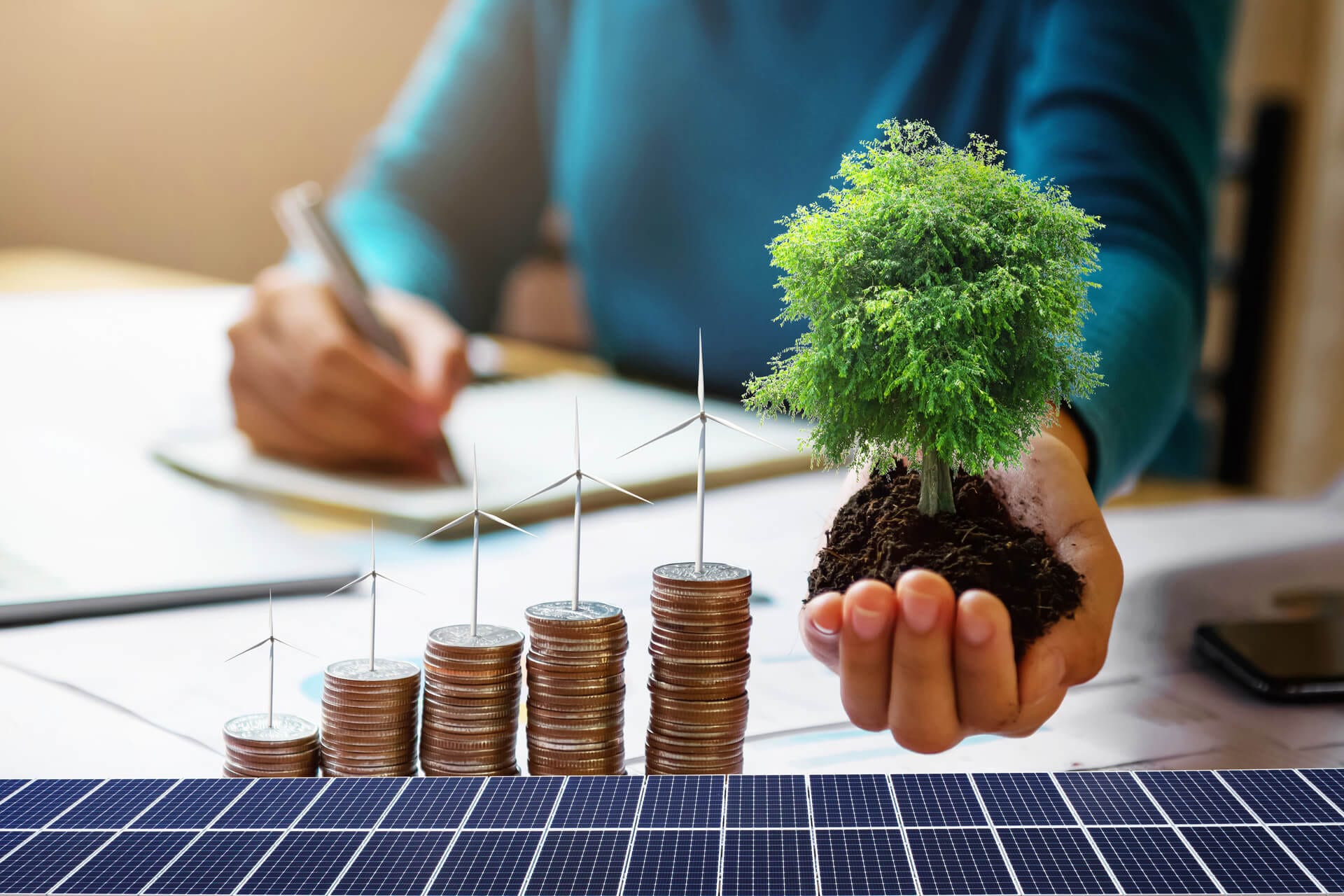 medium vecteezy businesswoman holding tree with turbine on coins and solar 8701055 medium 1